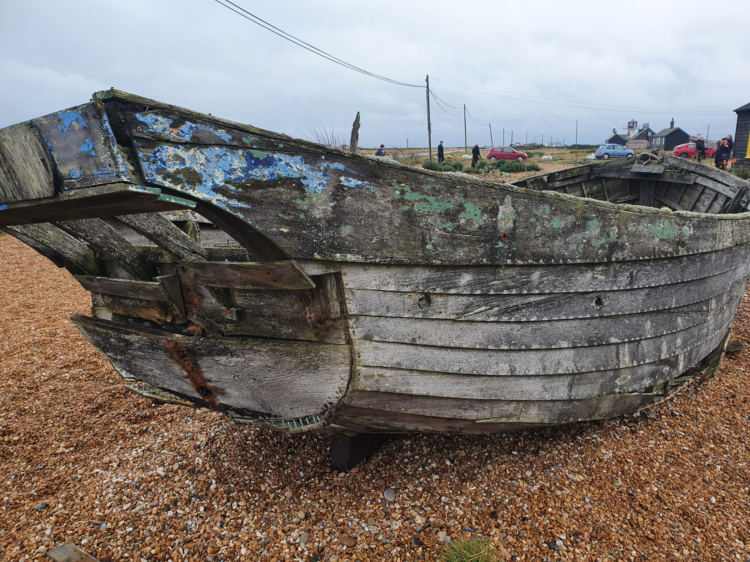 Wooden boat ashore pebble beach