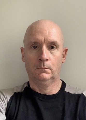 Portrait of Simon Hinde in front of white background